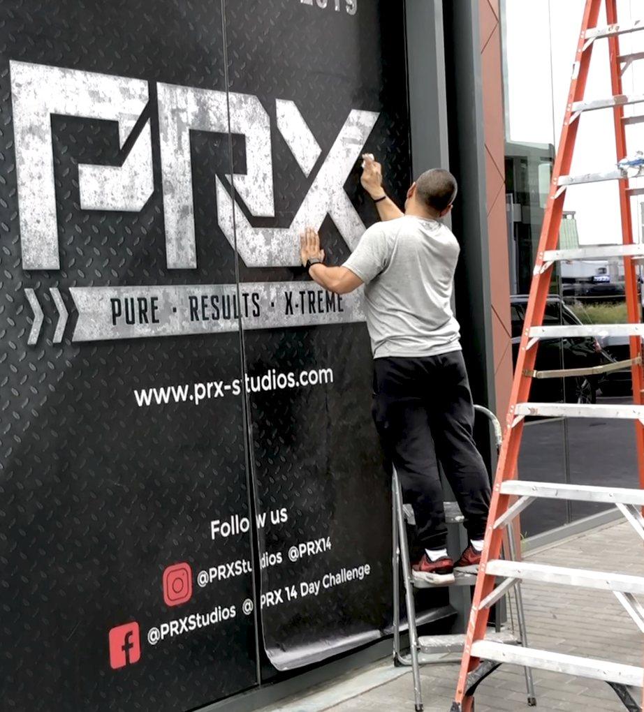 Installer applying a large storefront vinyl graphic