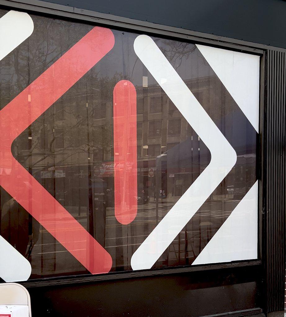 Bold red and white window graphics on a storefront